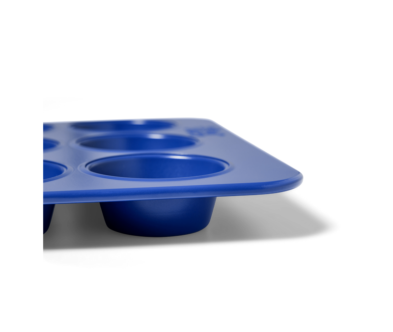 Great Jones | Stud Muffin - Blueberry, a nonstick, nontoxic muffin pan with four holes, ideal for baking muffins or cupcakes.
