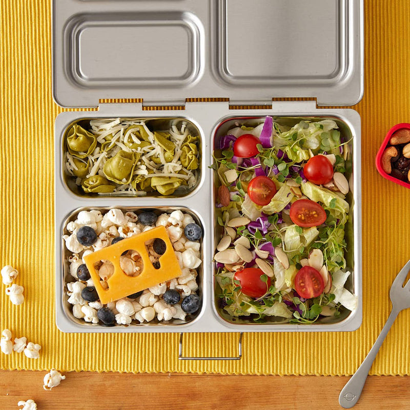 PlanetBox - Launch Stainless Steel Lunch Box displayed with popcorn, blueberries, and cheese, highlighting its spacious compartments for varied meal packing.