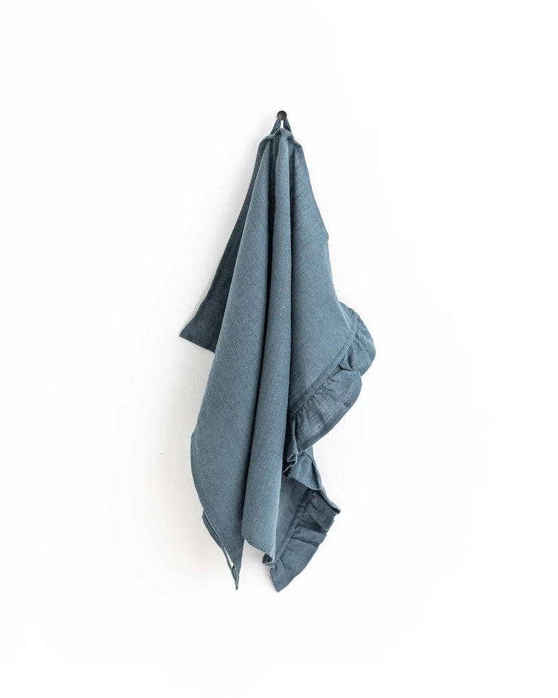 MagicLinen - Ruffle trim tea towel hangs on a hook, showcasing its soft linen texture and stylish ruffle design, ideal for kitchen use.