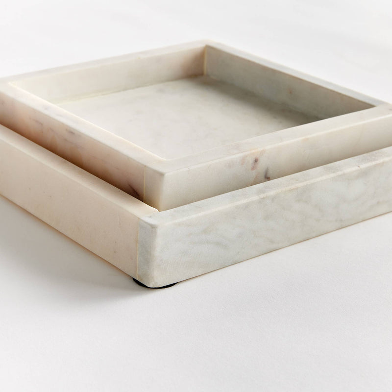 A close-up of the Amani Square Marble Trays set, highlighting their sleek, white surface, ideal for displaying pastries or decor in a kitchen or living room.