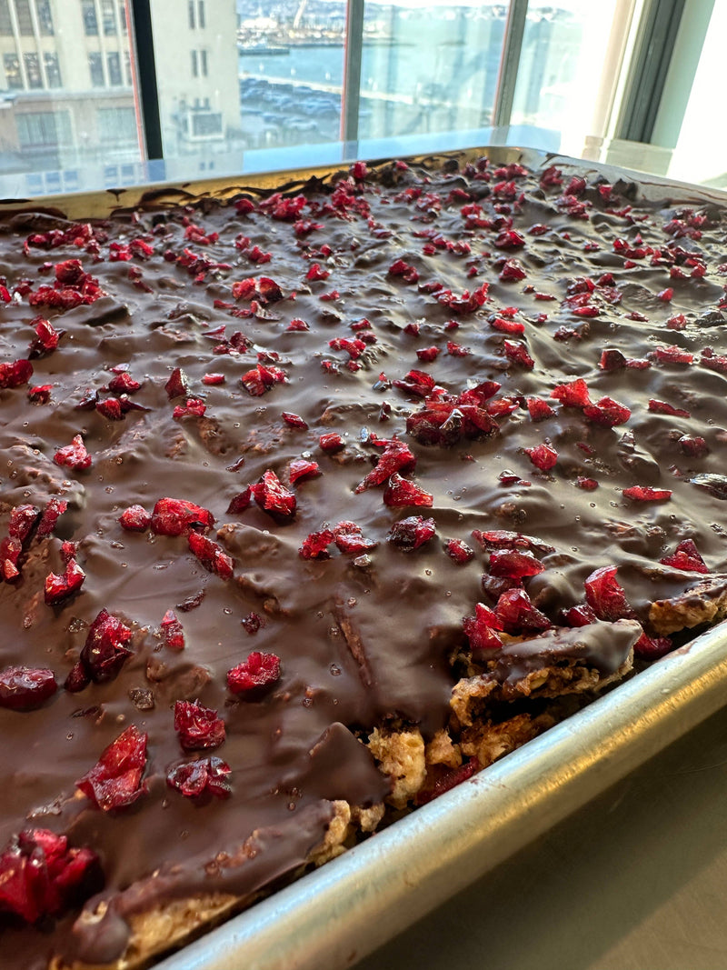Norwegian Baked - KnekkeGodis, a Nordic cookie toffee bark, featuring crispbread with caramel, dark chocolate, cranberries, and sea salt.