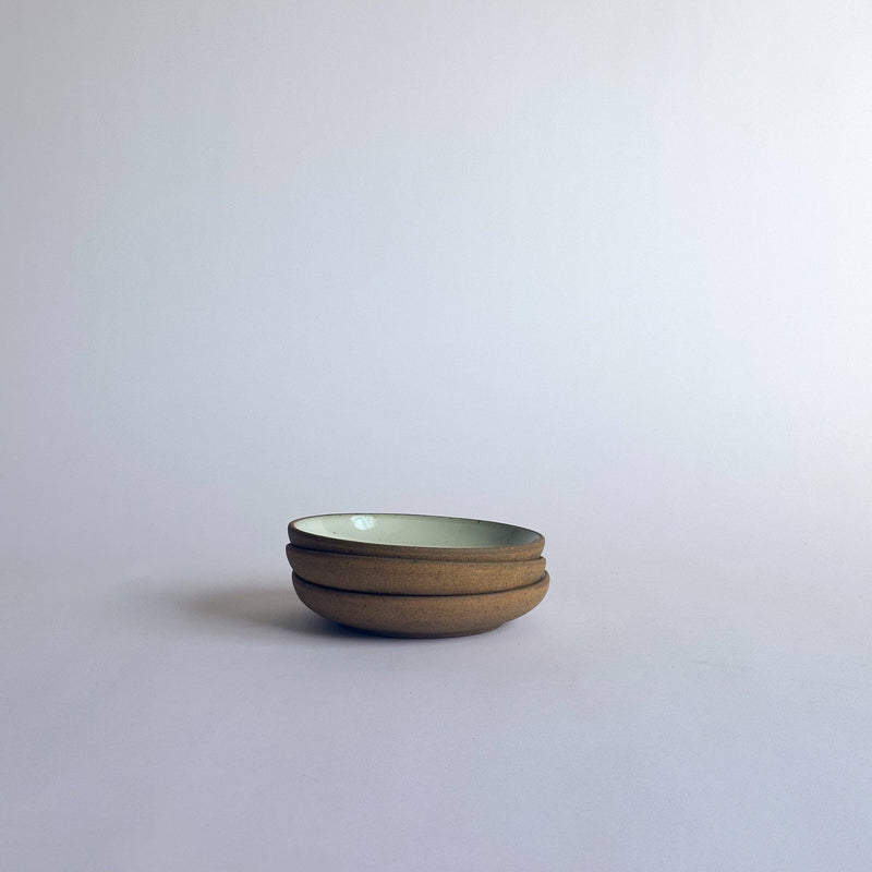 Sarah Kersten - Olive Dish: Basin Collection: Straw, a versatile shallow dish perfect for serving olives or bread, displayed in a stack on a white surface.