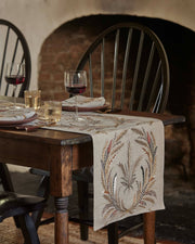 Coral & Tusk - Wheat Harvest Dinner Napkin, embroidered with wheat motifs, adorns a rustic table set for two, enhancing a cozy, countryside dining experience.