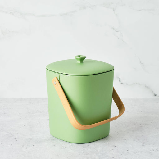 Bamboozle - Astrik Composter: Avocado; a compact, stylish green compost bin with bamboo handle, ideal for sustainable kitchens. Perfect for managing kitchen scraps efficiently.