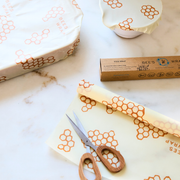 Bee's Wrap - Cut-to-Size Roll - Honeycomb with scissors, showcasing its versatile, customizable design for eco-friendly food storage solutions.