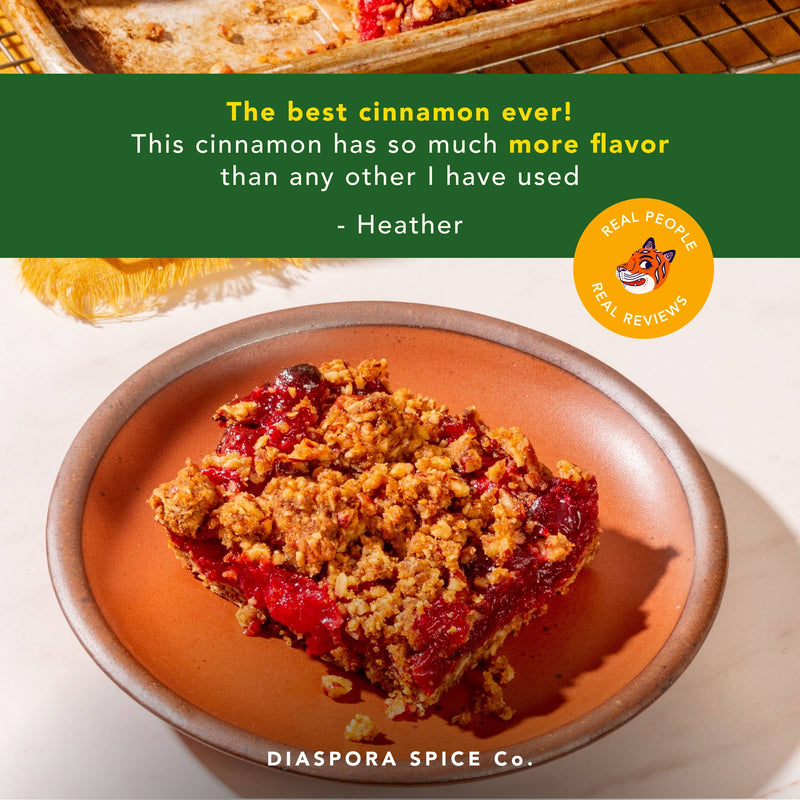 Diaspora Spice Co. - Peni Miris Cinnamon (Powder) showcased with a red-fruit crumble on a terracotta plate, featuring a glowing customer review and brand logo.
