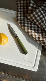 Material - The MK Free Board: Ocean, featuring a paring knife and peeled potato, embodies innovative, plant-based design for efficient, eco-friendly kitchen prep.