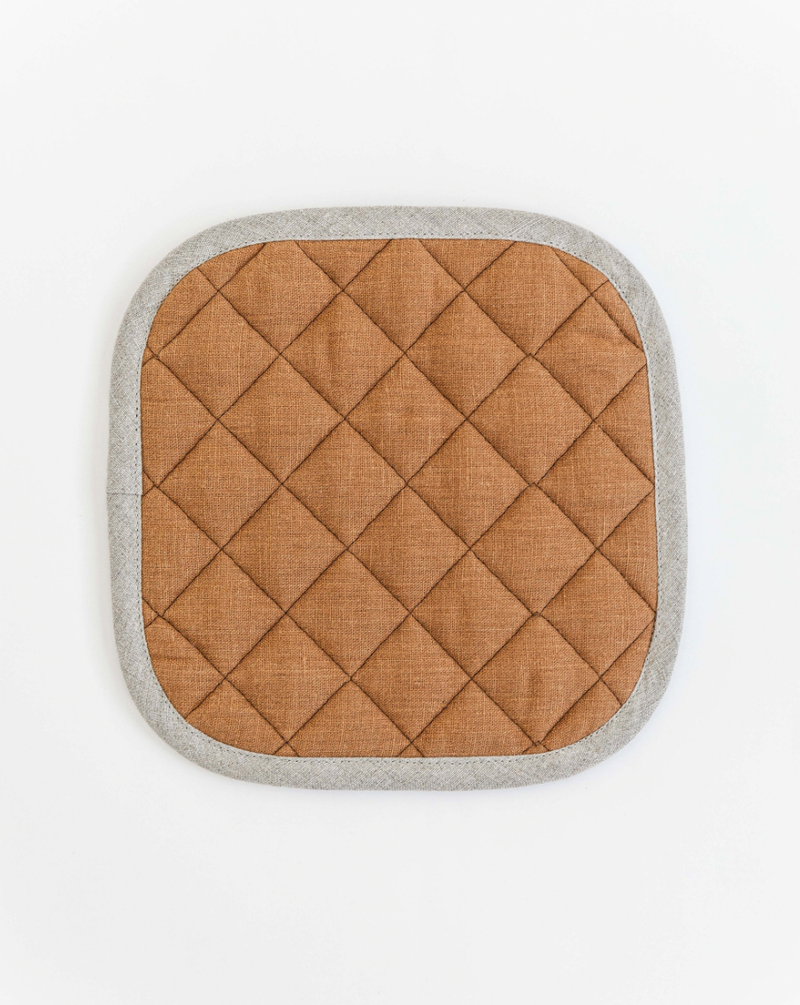 MagicLinen - Linen pot-holder: A brown square fabric pot holder with quilted detailing and a hanging loop, designed for heat protection in the kitchen.