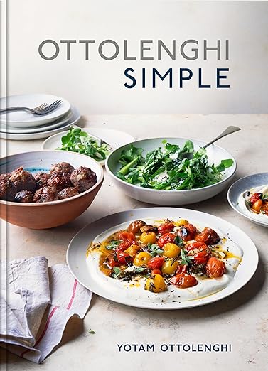 Cover of Ottolenghi Simple: A Cookbook by Yotam Ottolenghi, featuring dishes like meatballs, green salad, and roasted tomatoes, highlighting easy, flavor-forward recipes.