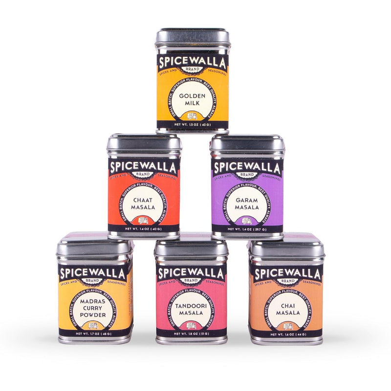 Spicewalla | Chai Pani Masala Collection 6 Pack Gift Set, featuring six spice blends in metal tins, stacked in a pyramid, for authentic Indian cooking.