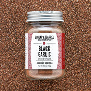 Burlap & Barrel - Black Garlic - Single Origin Spice & Seasoning in a glass jar from Aguacatán, Guatemala, showing its dark, finely ground garlic powder content.