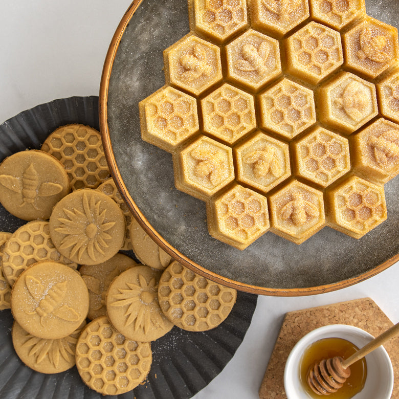 Nordic Ware Honeycomb Pull-Apart Pan displaying honeycomb-shaped cookies, perfect for creating 19 portioned cakelets, featured at Athens Cooks kitchen store.