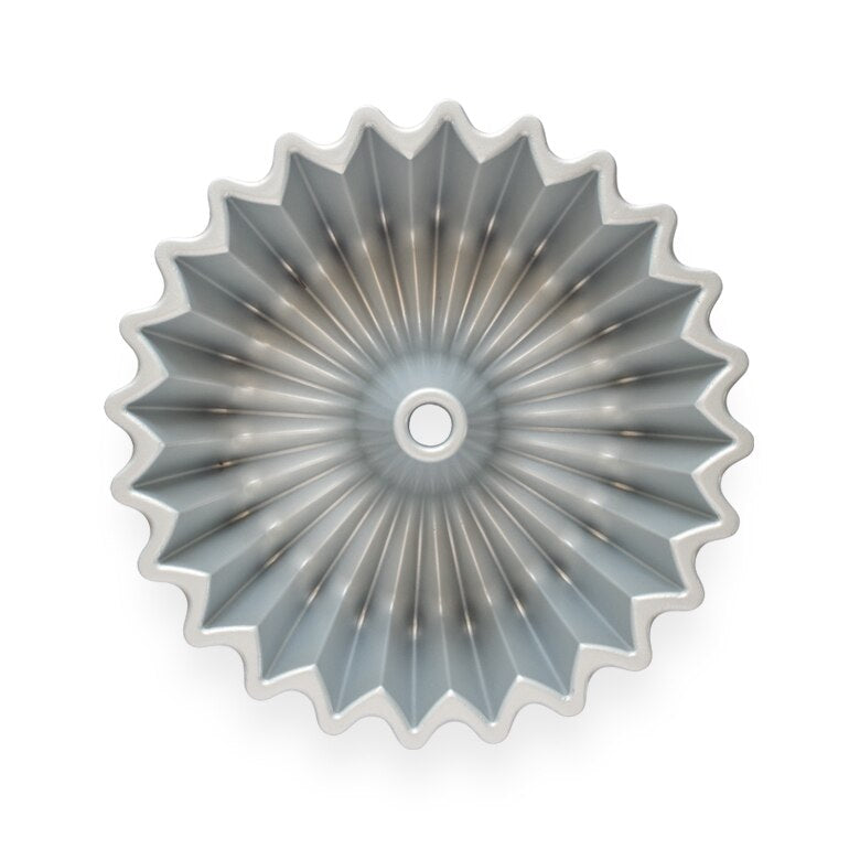 Nordic Ware | Brilliance Bundt® Pan, a circular cast aluminum pan with a hole, features a nonstick interior for even baking and easy release.