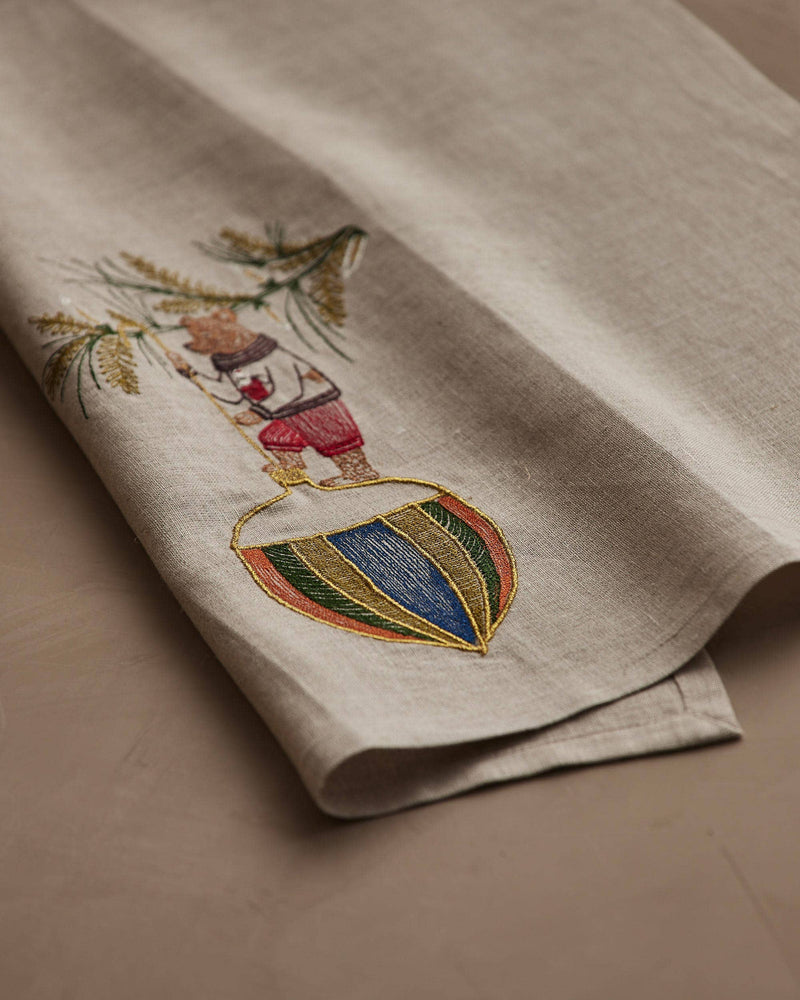 Coral & Tusk - Deck the Halls Bear Tea Towel featuring a whimsical bear embroidery in festive colors, ideal for holiday kitchen decor.