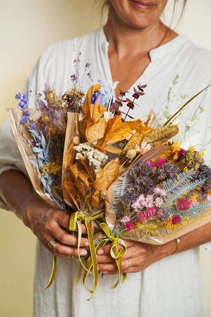 Idlewild Floral Co. - Christmas Mini Market Bouquet: Three wrapped dried flower bouquets with velvet ribbons, featuring purple, pink, yellow, and cream blooms, perfect for lasting decor.