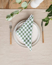 Set of 2 linen napkins on a plate with a fork, showcasing MagicLinen's stone-washed texture and versatility for table decor.