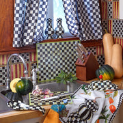 MacKenzie-Childs | Courtly Check Butter Box sits elegantly by a kitchen sink, surrounded by matching checkered decor and winter squash, enhancing the kitchen's charm.