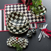MacKenzie-Childs | Courtly Check Butter Box on a slate surface, surrounded by matching checkerboard dishware, silver flatware, and fresh radishes, embodies a stylish, curated kitchen aesthetic.