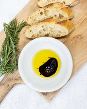 Frantoio Galantino Extra Virgin Olive Oil in Ceramic Jug, with close-up of bread, rosemary, and oil, reflecting artisanal craftsmanship and culinary excellence.