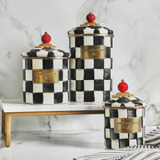 MacKenzie Childs | Courtly Check Small Canister set on a marble stand, featuring hand-painted checks and red knobs, ideal for stylish kitchen or home storage.