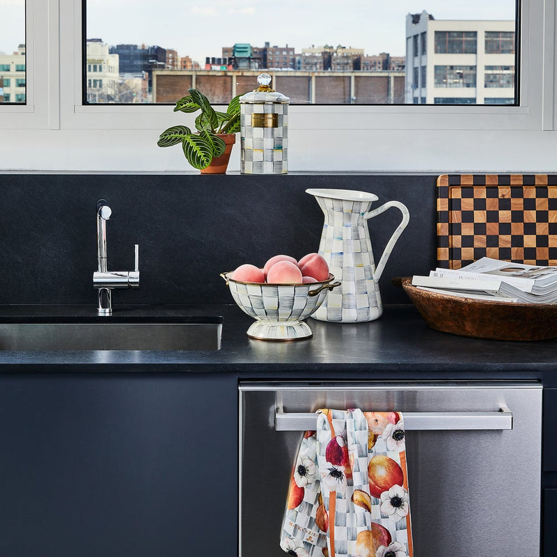 Sterling Check Large Canister by MacKenzie Childs on a modern kitchen counter, paired with a matching pitcher and bowl, amid a stylish urban kitchen setting.