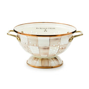MacKenzie-Childs | Mocha Check Small Colander: Oval, enameled colander with hand-painted checkerboard pattern, warm metallic rim, raised base, and antiqued brass-finished handles, ideal for kitchen tasks.