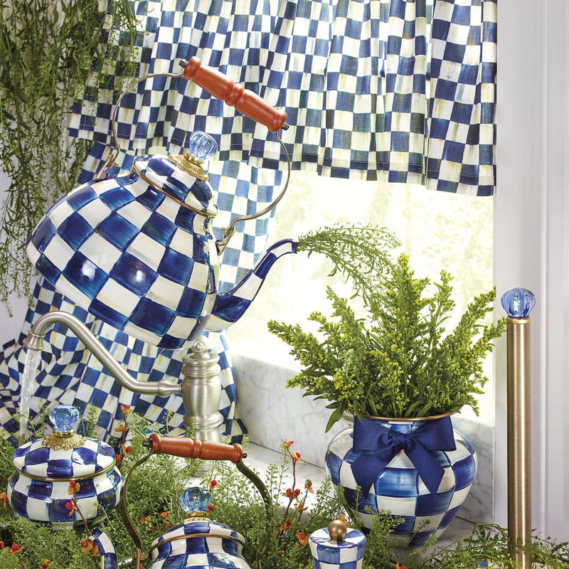 MacKenzie Childs | Royal Check Tea Kettle, 3 QT, with wooden handle, on a country-style kitchen counter, surrounded by matching blue-and-white checkerboard accessories.