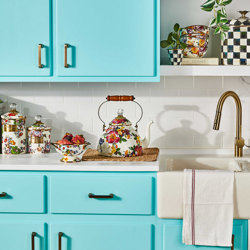 MacKenzie-Childs White Flower Market 3 Quart Tea Kettle on a marble countertop, styled with floral ceramic canisters and a floating shelf with eclectic kitchen decor.