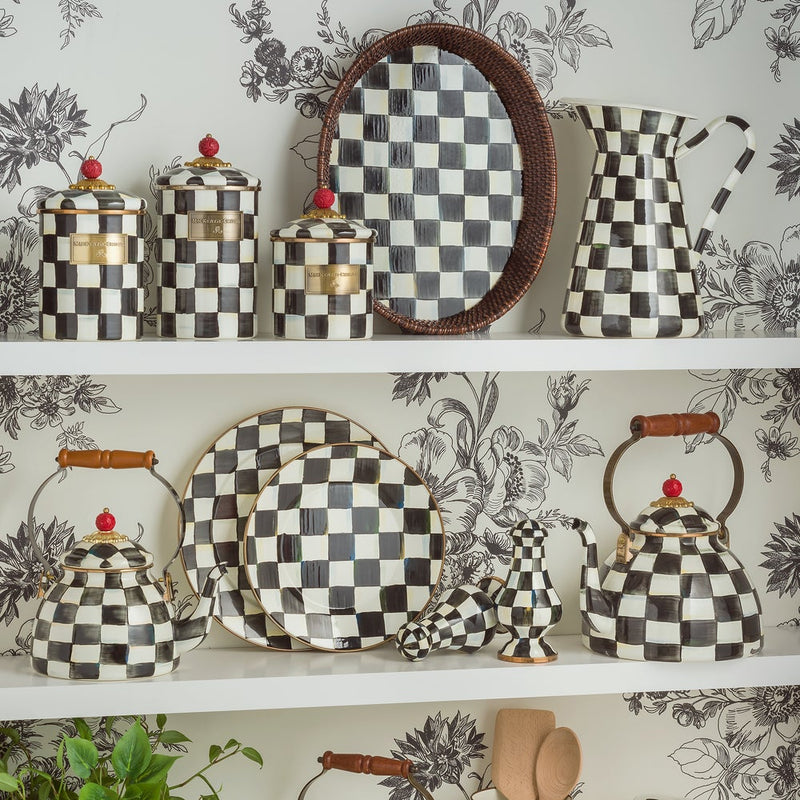 MacKenzie Childs | Courtly Check Tea Kettle, 3 QT., featuring hand-painted checks, wood handle, and brass-accented lid, displayed on a shelf with matching kitchenware.