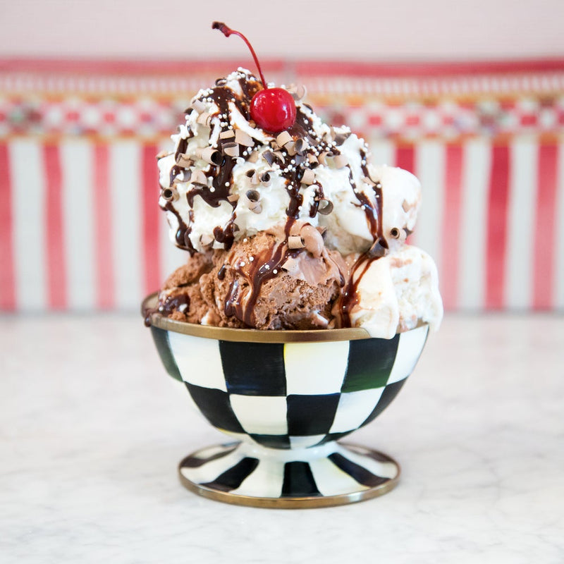 MacKenzie-Childs | Courtly Check Ice Cream Dish featuring a classic ice-cream sundae, showcasing its elegant black-and-white checkered design and bronzed rim.