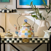 MacKenzie-Childs Confetti Check Tea Kettle, 2 QT, on a serving tray with matching ceramic pieces, epitomizing Athens Cooks' curated kitchen elegance.