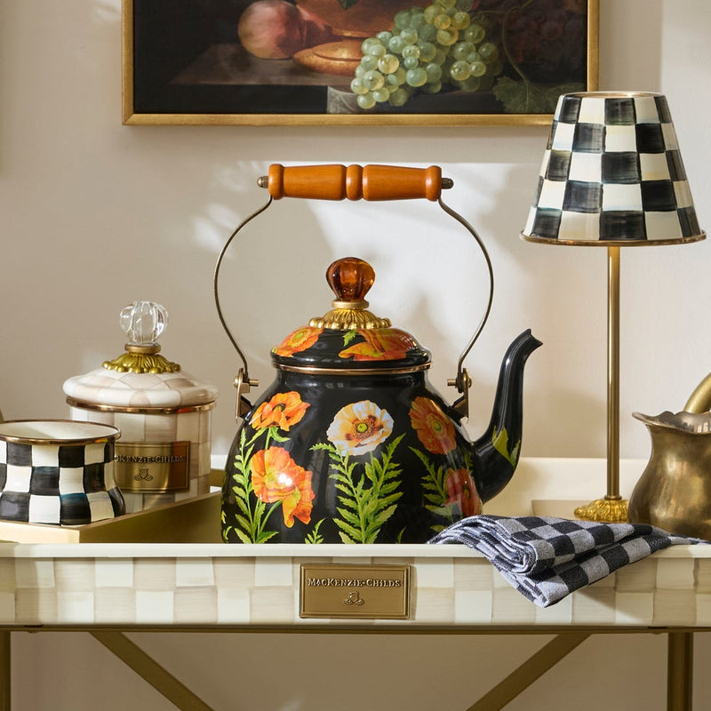 Mackenzie Childs Poppy Tea Kettle, 2 QT, on a decorative tray with matching canister, checkered cup, tea towel, and lamp, embodying Athens Cooks' curated kitchen style.