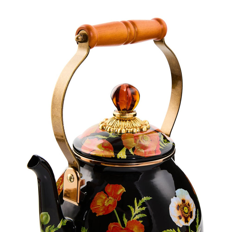 Mackenzie Childs | Poppy Tea Kettle, 2 QT. features a black enamel body with floral motifs, wood handle, brass fittings, and a decorative glass finial.