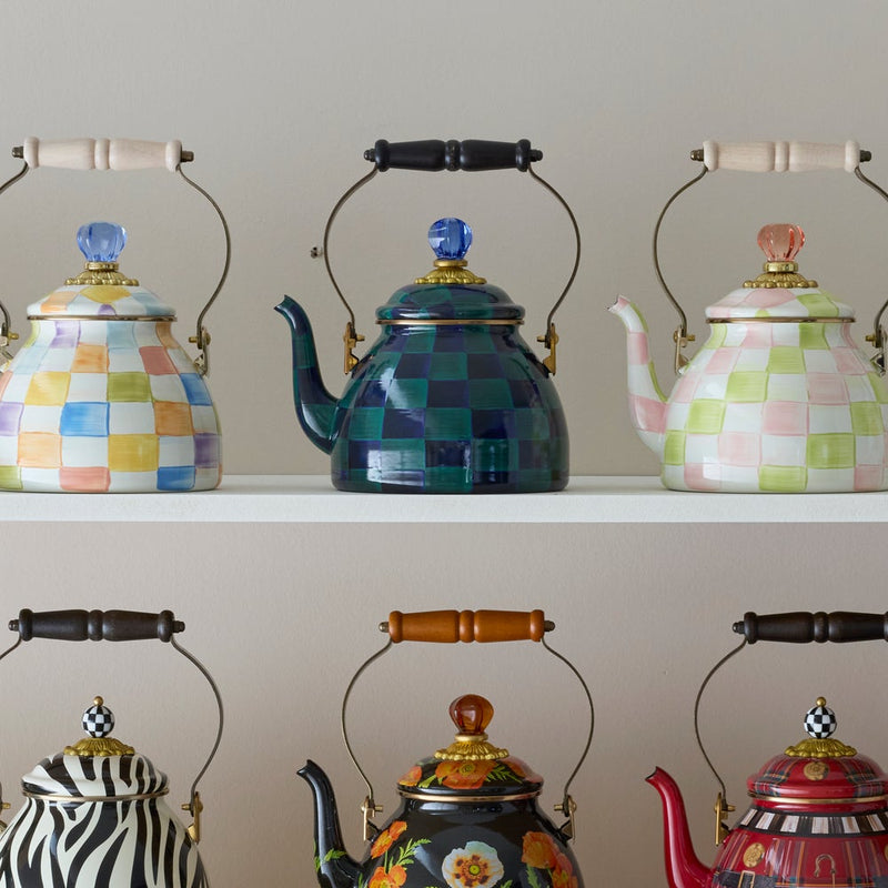 Mackenzie Childs | Juniper Check Tea Kettle, 2 QT., displayed on a white shelf, features a dark green and navy checkerboard pattern, curved spout, and wooden-handled lid.