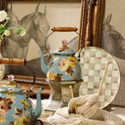 MacKenzie-Childs | Wild Rose Slate Tea Kettle, 2 Qt, elegantly displayed with floral motifs, alongside vintage decor, showcasing its dual functionality as kitchen art.