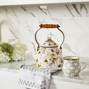 MacKenzie Childs | Wildflowers Pink Tea Kettle, 2 QT., with floral design, wooden handle, and crystal-style knob, displayed on a countertop with a matching mug and towel.