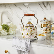MacKenzie Childs | Wildflowers Pink Tea Kettle, 2 QT, with floral designs on a marble counter, surrounded by matching floral canisters, lemon slices, and hydrangeas.