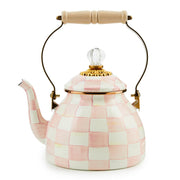 MacKenzie Childs | Rosy Check Tea Kettle, 2 QT features a pink-and-white checkerboard ceramic design, gold-tone lid band, glass knob, and wooden-handled metal curve.