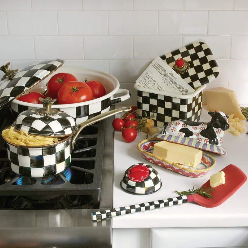 MacKenzie-Childs Courtly Check Recipe Box on a checkered countertop, open with a handwritten card inside, surrounded by fresh tomatoes and matching cookware.