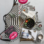 Stylized flat-lay featuring MacKenzie-Childs Courtly Check Recipe Box with recipe cards, cookbook, and baking tools, showcasing elegant kitchen organization and decorative flair.