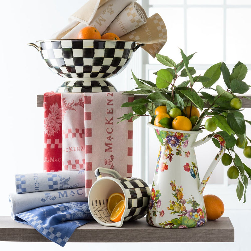 MacKenzie-Childs | Courtly Check 7 Cup Measuring Cup, uniquely hand-glazed, displayed with matching bowl and floral pitcher on wooden shelving, exemplifying functional elegance for the kitchen.