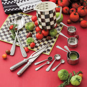 MacKenzie-Childs Courtly Check 7 Cup Measuring Cup with checkerboard design, surrounded by fresh tomatoes, tomatillos, rosemary, and matching utensils, highlighting elegance and practicality.