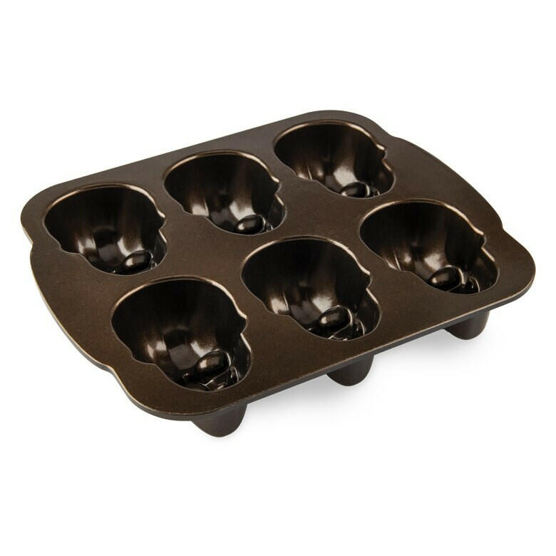 Nordic Ware Skull Cakelet Pan with six skull-shaped cavities for baking detailed mini skull cakes. Ideal for Halloween-themed treats.