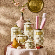 MacKenzie Childs Mocha Check Utensil Holder displayed among decorative containers, showcasing its hand-painted coffee-colored checks, ideal for kitchen organization.