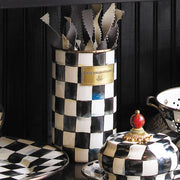 MacKenzie Childs | Courtly Check Utensil Holder in black-and-white checkered pattern, featuring zig-zag utensils, with matching canister and plate, part of a coordinated serve-ware collection.