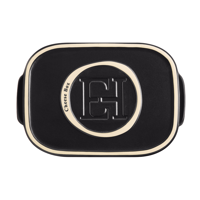 Emile Henry Cheese Box in clay, features matte black finish with cream trim, embossed lid, designed for preserving cheese, doubles as serving platter.
