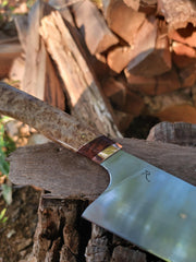 Rhymer Knives | 8 Chef Knives - African Blackwood + Rams Horn with Copper Bolster, showcased on a log, highlighting its hand-forged craftsmanship and superior handling features.