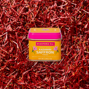 Diaspora Spices Co. - Kashmiri Saffron (Grade A Threads), single-origin spice tin surrounded by loose saffron strands, showcasing premium quality from Pampore's historic saffron district.