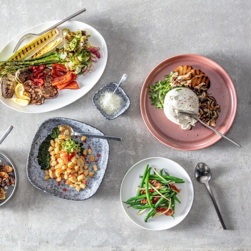 Zwiesel Fortessa | Arezzo Flatware Serving Set, Brushed, elegantly complements a vibrant vegetable spread, enhancing tabletop aesthetics with its sleek, durable 18/10 stainless steel design.