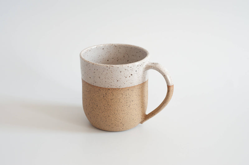 RachaelPots - 12 Oz Original Mug: Sage, hand-thrown ceramic mug with a speckled tan base and white glaze, featuring a thumb rest handle, perfect for beverages.